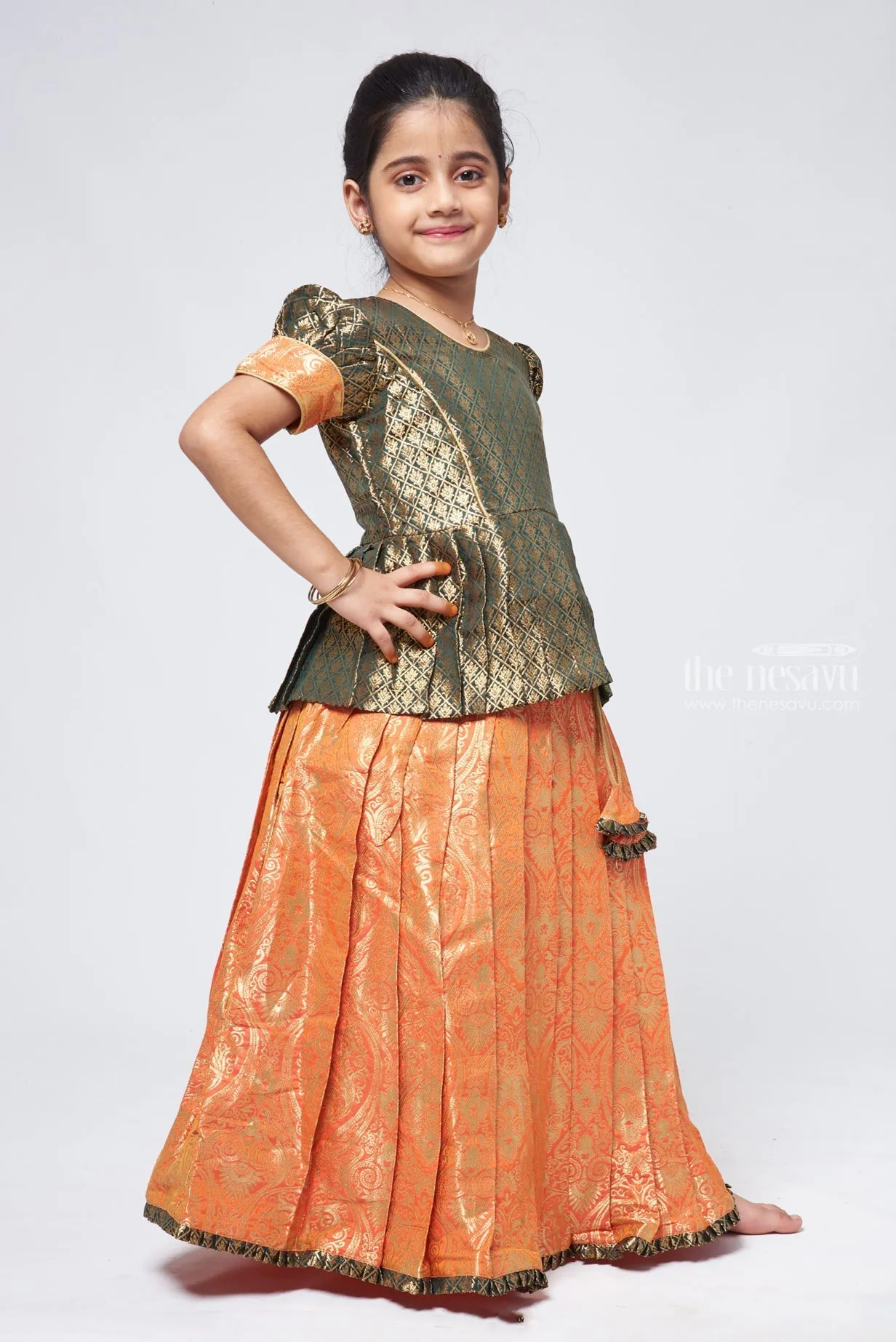 Elegant Brocade Peplum Green Blouse paired with Banarasi Salmon Pink Pattu Pavadai: Timeless South Indian